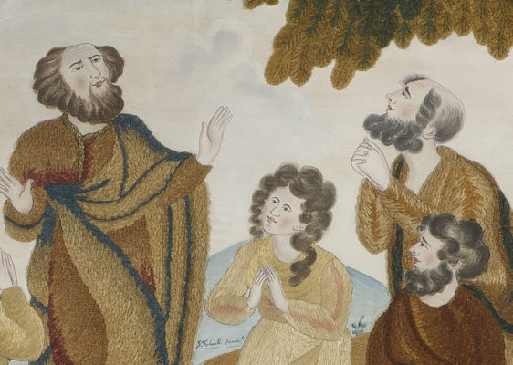 Detail of praying people with embroidered clothing and painted faces.